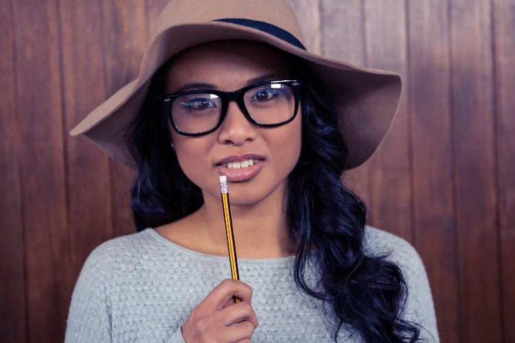 Girl Poses Wearing Eye Glasses Holding Pencil